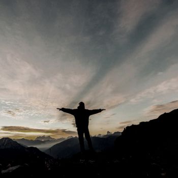 a man standing on top of the mountain